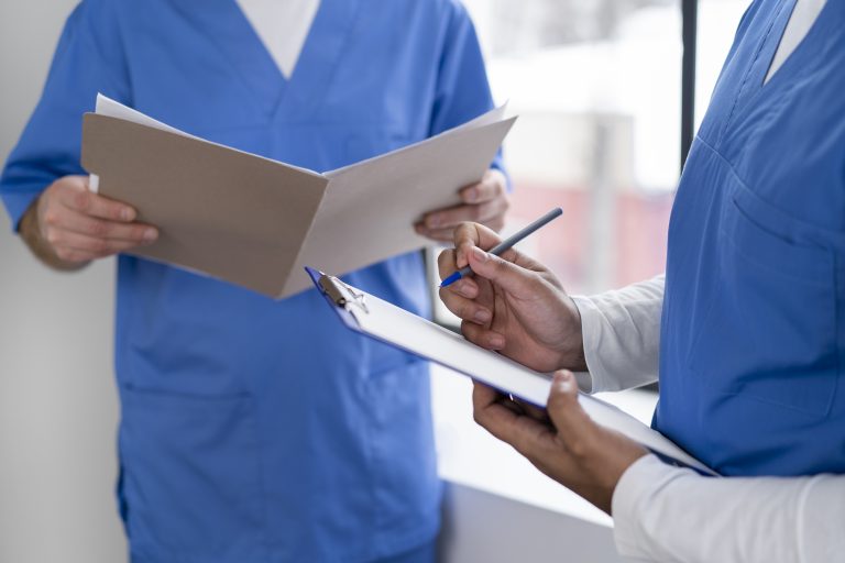 nurses with documents at hospital